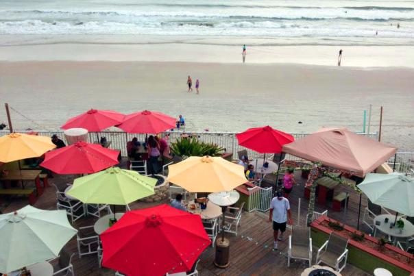 Colorful umbrellas dot the deck at a Daytona Beach oceanfront restaurant