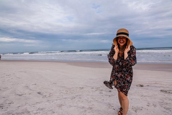 Woman standing on the beach with horizon in the background