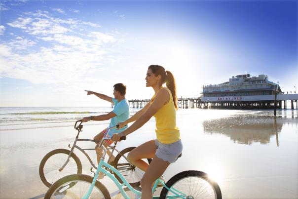 Couples riding bikes at sunrise.