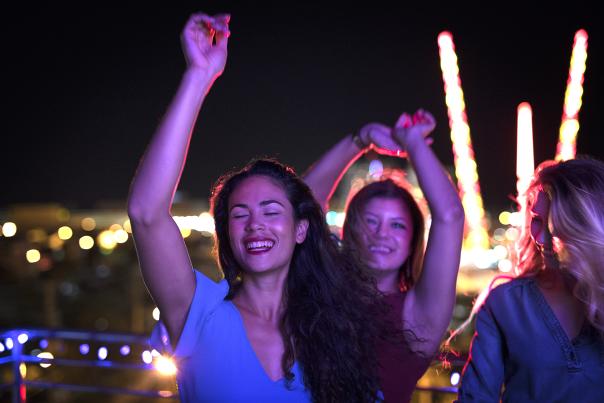 Friends dance under a festive night sky in Daytona Beach