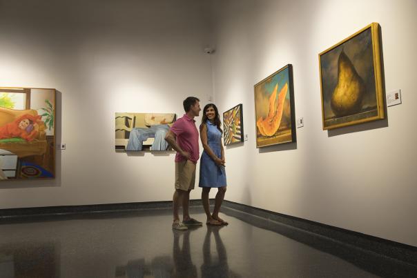 A couple views an art exhibit at a Daytona Beach museum.