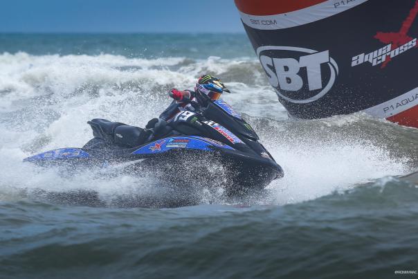 Person, in a competition, on a jet ski in the ocean off of Daytona Beach.