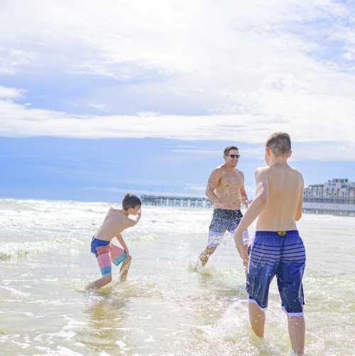 Kids playing on the beach in the water