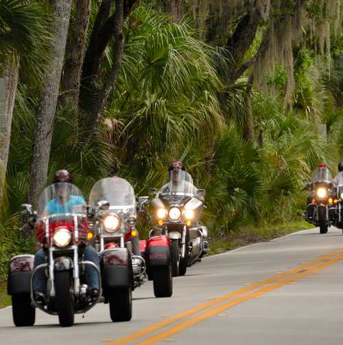 Motorcycle riders riding The Loop, a 34-mile tree lined scenic route, during Biketoberfest in Daytona Beach, Florida.
