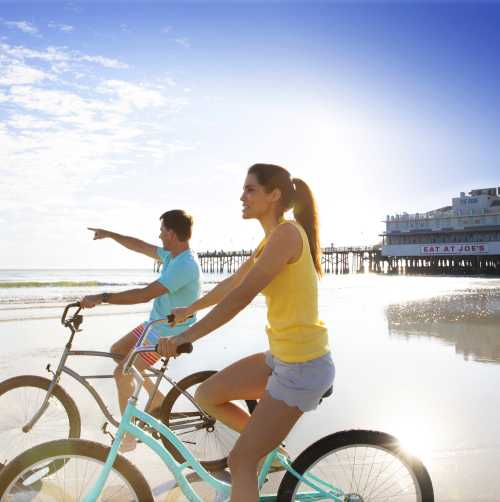 Couples riding bikes at sunrise.