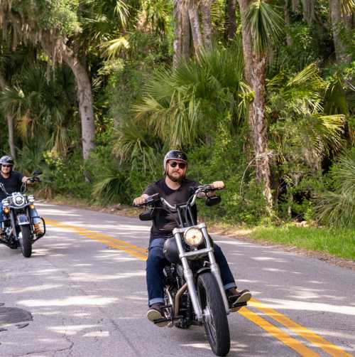 Motorcycle riders riding The Loop, a 34-mile tree lined scenic route, during Biketoberfest in Daytona Beach, Florida.