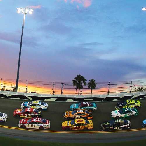 Cars racing on the Daytona track during the Coke Zero Sugar 400 race.