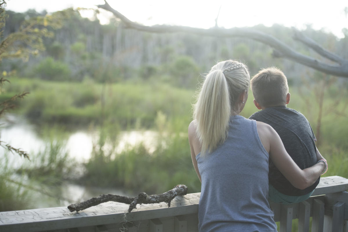 Women and Boy hiking by the water