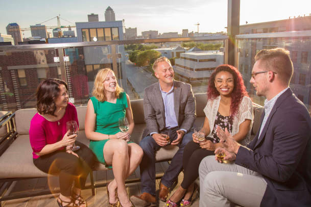 Business group having drinks on rooftop bar at The Republic on Grand