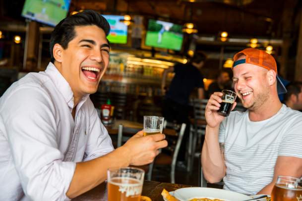 Friends Enjoying Drinks and Food at the Iowa Taproom