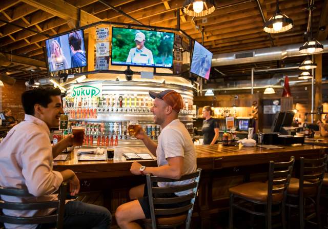A pair of friends enjoying a beer at Iowa Taproom
