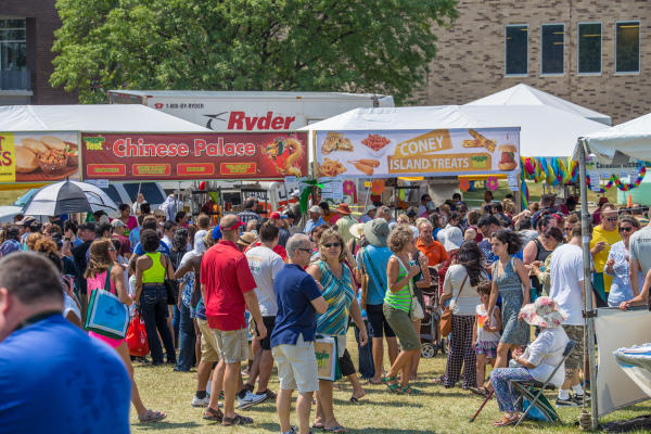 people enjoying an outside festival called Veggie Fest