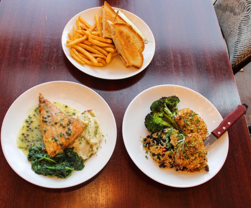 meals at Reserve 22. On the table you have a Turkey Panini, White Fish Picata, and Pork Chops with Grilled Broccoli and Rice.