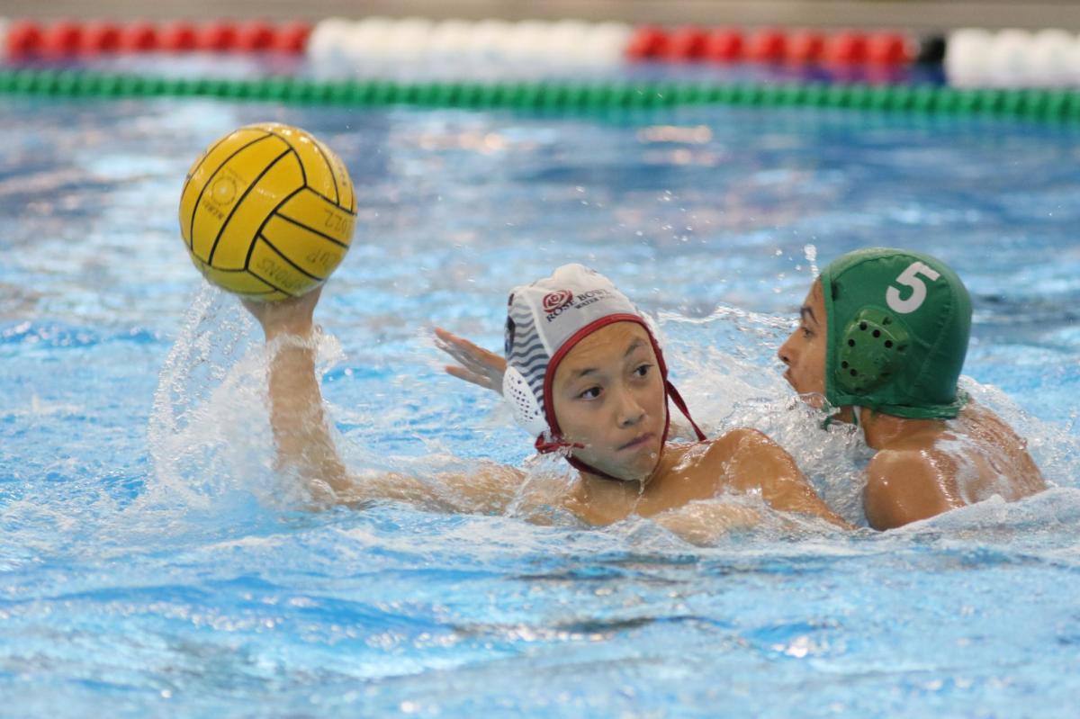 Young water polo players in pool during match