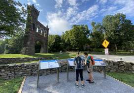 Two women looking at the National War Correspondents Memorial Arch