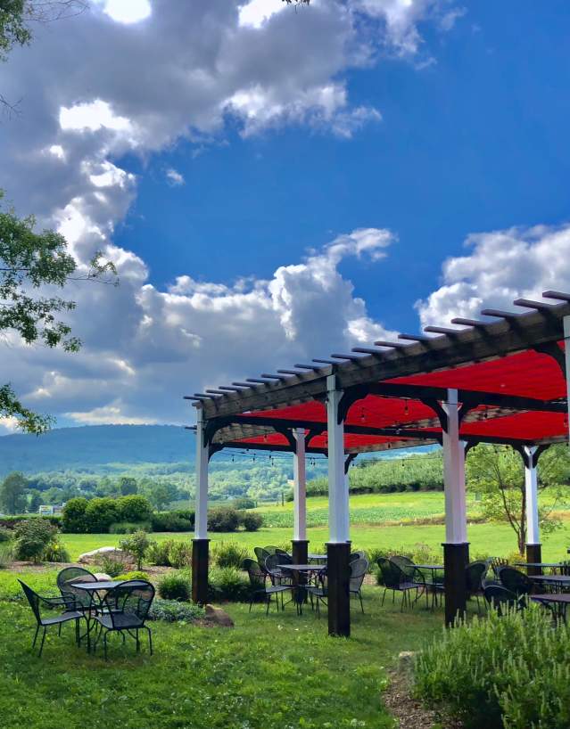 Gazebo and patio tables and chairs on the lawn at Catoctin Breeze Vineyard