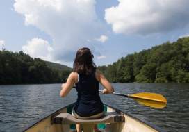 Woman paddling a canoe in the water in Frederick, MD