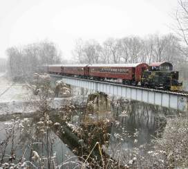 Walkersville Southern Railroad Santa Train going over a bridge during the snow