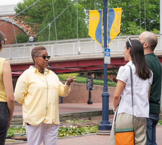 Tour guide Dee Jenkins from AARCH Society leading a guided walking tour on Carroll Creek Park in Downtown Frederick.