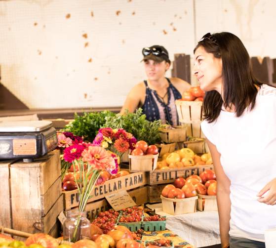 Woman purchasing fresh produce at the Farmers Market