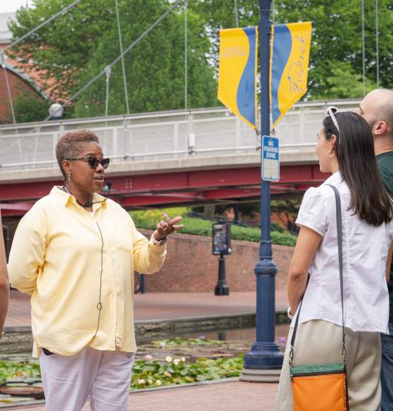 Tour guide Dee Jenkins from AARCH Society leading a guided walking tour on Carroll Creek Park in Downtown Frederick.