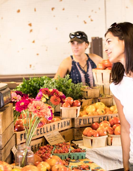 Woman purchasing fresh produce at the Farmers Market