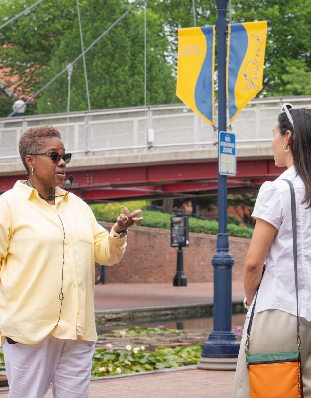 Tour guide Dee Jenkins from AARCH Society leading a guided walking tour on Carroll Creek Park in Downtown Frederick.
