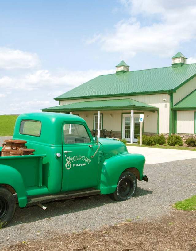 Old truck painted mint green with Stillpoint Farm painted on the side at the Milkhouse Brewery