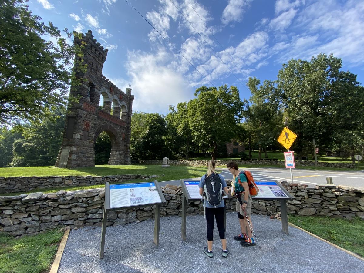 Two women looking at the National War Correspondents Memorial Arch