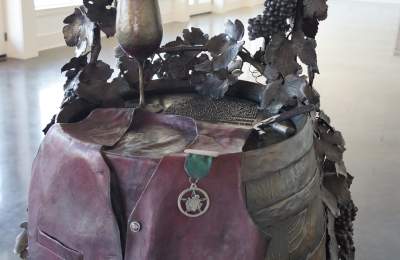 Serving Texas Wine, One Glass at a Time bronze sculpture in Grapevine, Texas
