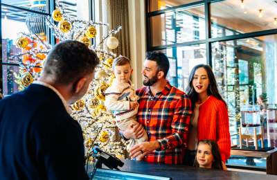 A family checking into a hotel in Grapevine during the Christmas Capital of Texas