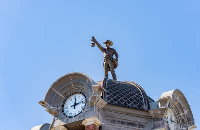 The Grapevine Nightwatchman sculpture atop city hall in Grapevine, Texas