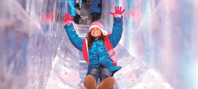 Child enjoying SNOW! slide at Gaylord Texan Resort