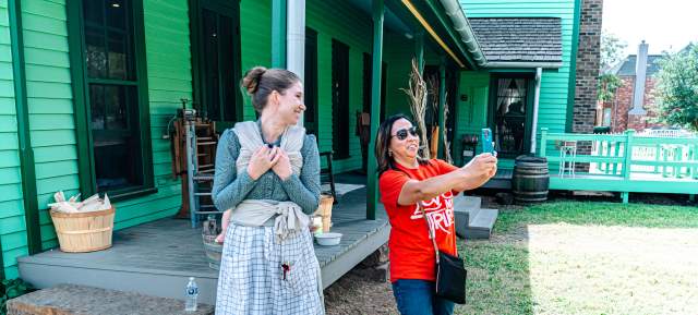 Nash Farm employee poses with a guest as they take a selfie