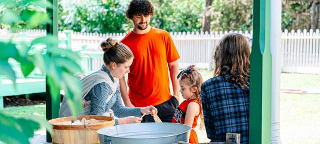 Kids learning from Nash Farm employees