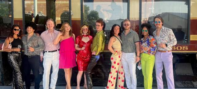 People dressed up in disco attires before they ride on the Grapevine Vintage Railroad's Disco Wine Trail