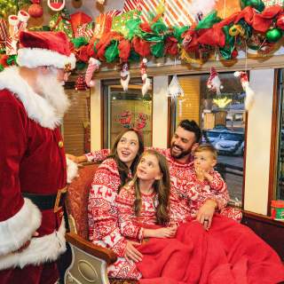 Family on board Santa's North Pole Express in Grapevine, Texas during the Christmas Capital of Texas