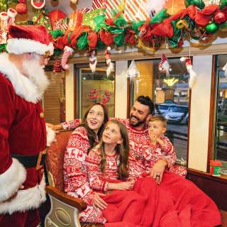 Family on board Santa's North Pole Express in Grapevine, Texas during the Christmas Capital of Texas