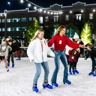 Skaters enjoying Peace Plaza Ice Rink in Grapevine during Christmas Capital of Texas