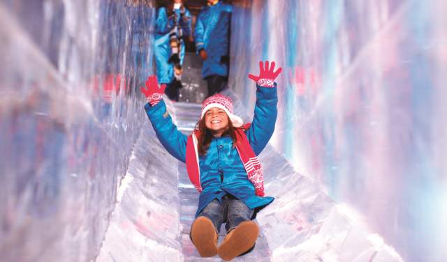 Child enjoying SNOW! slide at Gaylord Texan Resort