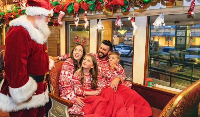 Family on board Santa's North Pole Express in Grapevine, Texas during the Christmas Capital of Texas