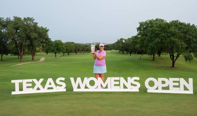 Angela Stanford holding Texas Women's Open trophy for Legends division