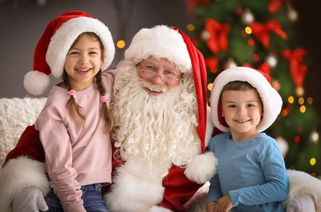 Kids taking a photo with Santa Claus