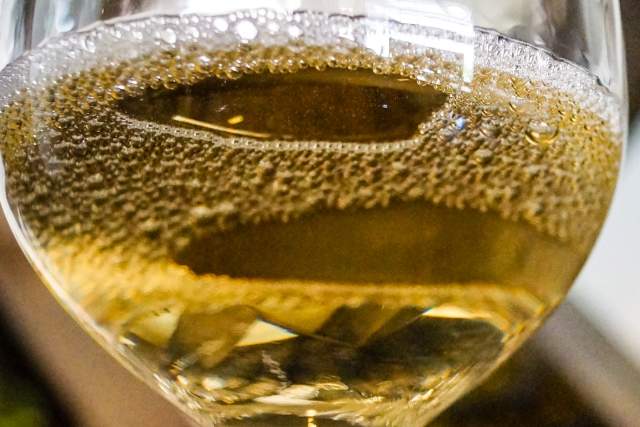 A glass filled with white wine