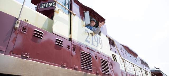 Train Conductor waiving on train