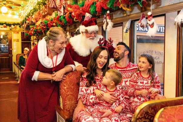 Family on board Santa's North Pole Express in Grapevine, Texas during the Christmas Capital of Texas