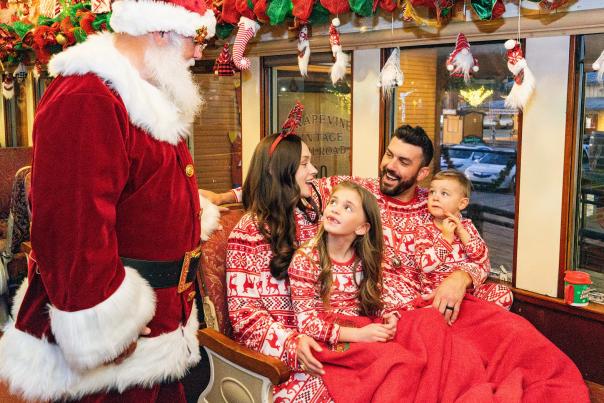 Family on board Santa's North Pole Express in Grapevine, Texas during the Christmas Capital of Texas