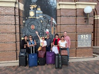 Visitors with their bags outside Grapevine Main Station in Grapevine, Texas