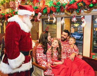 Family on board Santa's North Pole Express in Grapevine, Texas during the Christmas Capital of Texas