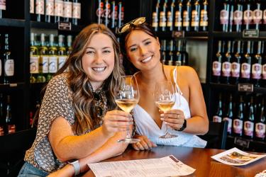 Women toasting glasses of wine in Grapevine, Texas